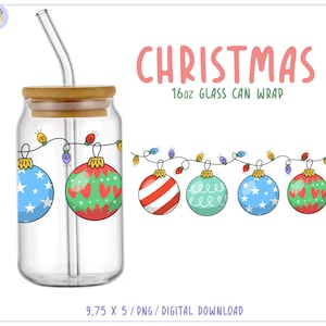 May include: A clear glass can with a bamboo lid and a glass straw. The can is decorated with a string of Christmas lights and ornaments. The ornaments are blue with white stars, red with green hearts, and red and white stripes. The text "CHRISTMAS 16oz GLASS CAN WRAP" is above the ornaments.