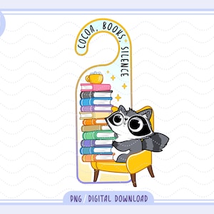 May include: A whimsical door hanger featuring a raccoon wearing glasses, sitting on a yellow chair next to a stack of colorful books. The top of the hanger reads "COCOA, BOOKS, SILENCE". A cup of cocoa sits atop the books.