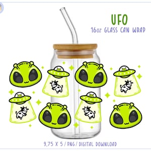 May include: A clear glass can wrap with a bamboo lid and a glass straw. The wrap features a repeating pattern of green alien faces and UFOs beaming up cows. The text "UFO 16oz Glass Can Wrap" is in green.