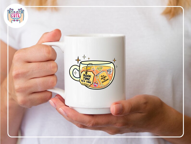 May include: White ceramic mug with a whimsical illustration of tea and books. The mug features the text "Book Time Tea Time" on a tag and "Tea brewed by magic" on a book. The design includes stars and a crown, suggesting a magical theme.
