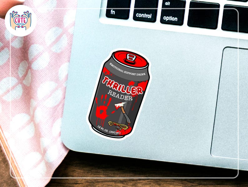 May include: A sticker of a black can with red accents, labeled "Thriller Reader" with a bloody handprint and an axe graphic. The can is labeled "Emotional Support Drink" and "12 fl oz (350 ml)".