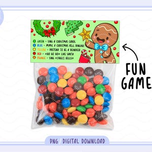 May include: A clear plastic bag filled with colorful candies, with a festive Christmas-themed game card attached. The card features a gingerbread man illustration and instructions for a fun holiday game. Text on the card includes "FUN GAME" and "PNG / DIGITAL DOWNLOAD."