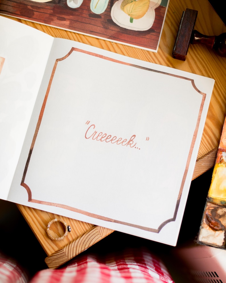May include: A white page with a brown border, the words "Creceeeek..." are written in pink on the page.