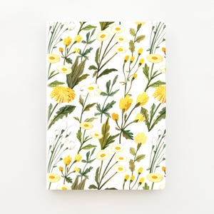 May include: A rectangular notebook with a white cover featuring a repeating watercolour pattern of yellow wildflowers, dandelions, and green leaves. The botanical illustration covers the entire front surface with various stems and blossoms.