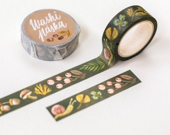 May include: A roll of green washi tape with a forest theme. The tape features illustrations of mushrooms, leaves, snails, and berries. The tape is labeled "Washi Näska".