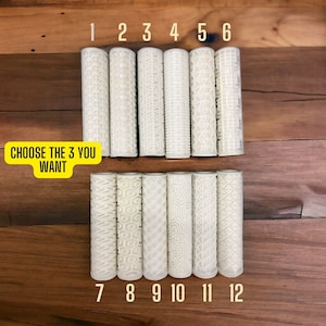 May include: Twelve white rolling pins with different embossed patterns. Choose three rolling pins from the selection.  The rolling pins are numbered 1 through 12.