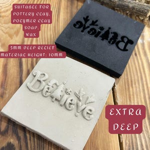 May include: Two square stamps, one black and one off-white, with the word "Believe" in relief. The black stamp has a Christmas tree and reindeer design. The off-white stamp has the word "Believe" with a Christmas tree and snowflake. The text on the image says "Suitable for pottery clay, polymer clay, soap, wax. 5mm deep relief, material height: 10mm, extra deep."
