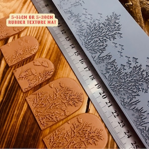 May include: Five brown rubber texture mats with a tree design. The mats are 5 inches by 14 inches or 5 inches by 30 inches. A ruler is in the background.