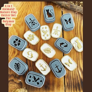 May include: An assortment of polymer clay cutters in various shapes, including a cat, butterfly, turtle, and flower. The cutters are in gray and white, with gold accents. The text "8 in 1 Animal & Nature Clay Cutter Set For Polymer Clay" is visible.