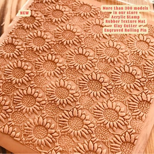 May include: A close-up of a brown textured rolling pin with a sunflower pattern. The rolling pin is new and is part of a collection of over 300 models. The text "NEW" is visible in the top left corner of the image.