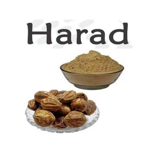 May include: A bowl of Harad powder, a brown powder, and a plate of brown, dried Harad fruit.