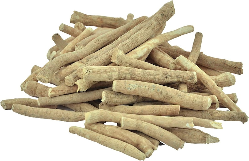 May include: A pile of ashwagandha root pieces, showcasing a light tan color and a rough, textured surface. The roots vary in size and shape, with a natural, organic appearance. The image is set against a plain white background.