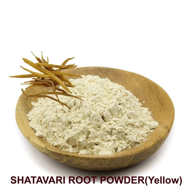 May include: A wooden bowl filled with light beige Shatavari root powder. A few dried Shatavari root pieces are visible on the side of the bowl.  SHATAVARI ROOT POWDER(Yellow)