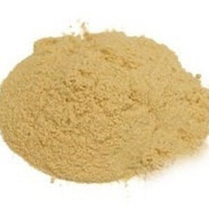 May include: A close-up of a pile of light brown powder. The powder is fine and uniform in texture.