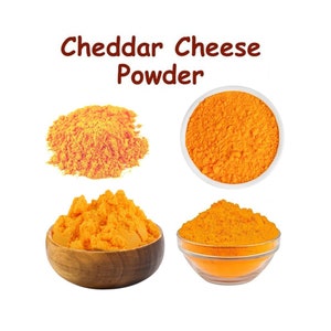 May include: A close-up of cheddar cheese powder in four different containers. The powder is a bright orange colour and has a fine texture. The containers are a white bowl, a clear glass bowl, and two wooden bowls.