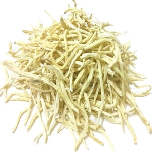May include: A pile of dried, light beige, thin, fibrous plant stalks. The stalks are long and slender, with a slightly rough texture.