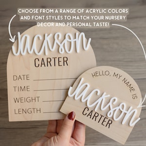 May include: Two arched wooden plaques featuring white 3D acrylic lettering. The larger plaque includes fields for DATE, TIME, WEIGHT, and LENGTH. The smaller plaque displays the text HELLO, MY NAME IS above the name Jackson Carter in white script.