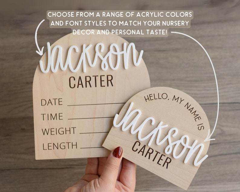 May include: Two arched wooden plaques featuring white 3D acrylic lettering. The larger plaque includes fields for DATE, TIME, WEIGHT, and LENGTH. The smaller plaque displays the text HELLO, MY NAME IS above the name Jackson Carter in white script.
