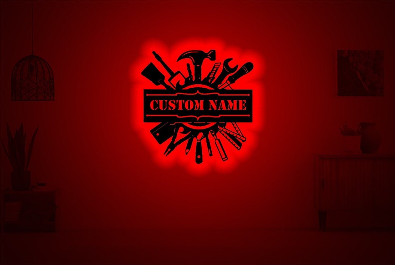 May include: Black silhouette of various tools arranged in a circle with a banner that reads "CUSTOM NAME". The image is set against a red background.