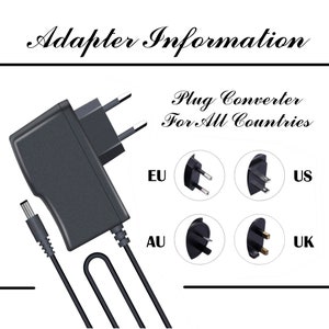 May include: A black power adapter with a cord and a plug converter for all countries. The adapter has a US plug, EU plug, UK plug, and AU plug.
