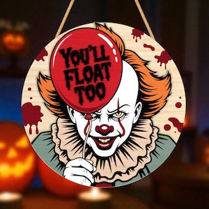 May include: Round wooden Halloween decoration featuring a menacing clown holding a red balloon with the text "You'll Float Too." The clown has orange hair, white face paint, and a sinister smile. Red blood splatters are around the edges.