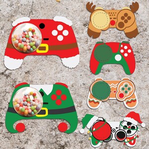 May include: Five Christmas-themed game controller treat holders. The controllers are decorated with red and white, green and white, brown and white, and red and white with a Santa hat. Each controller has a clear plastic circle in the centre for holding sweets or small treats.