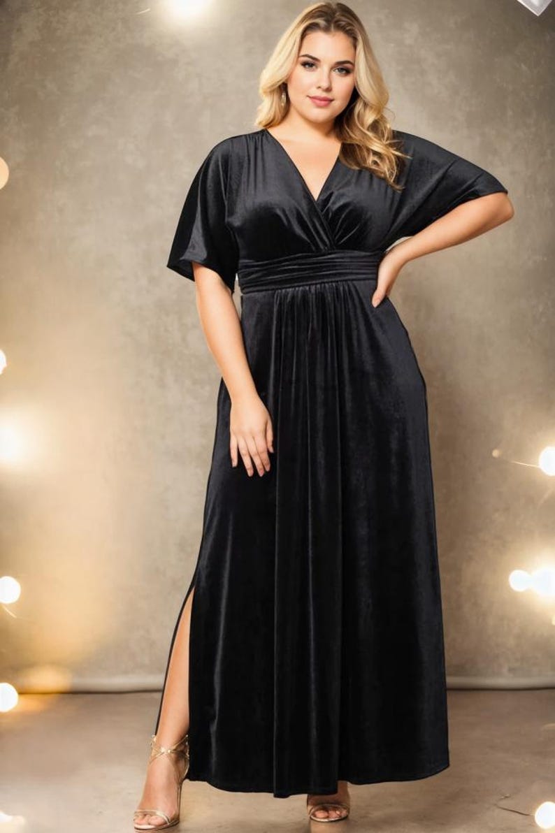 May include: A black velvet maxi dress with a V-neckline, short sleeves, and a side slit. The dress has a fitted bodice and a flowing skirt.