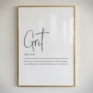 May include: A framed print with the word "Grit" in a stylish script font. Below the word is the definition of grit, describing drive, stamina, and fortitude. The frame is gold, and the background is white.