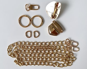 May include: Gold-toned metal hardware set for a bag or purse. The set includes two swivel clasps, two D-rings, two jump rings, a chain, and a lobster clasp.