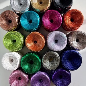 May include: Assortment of spools of metallic thread in various colors, including silver, gold, copper, turquoise, magenta, green, orange, lavender, white, dark green, gray, black, pink, purple, and blue.