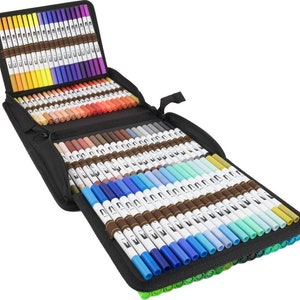 May include: A black zippered case containing a set of 100 dual-tip art markers. The markers are arranged in rows by colour, with shades of green, blue, purple, pink, orange, yellow, brown, and grey.