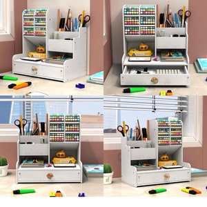 May include: White desktop organizer with multiple compartments for storing pens, pencils, markers, and other office supplies. It features a drawer for additional storage and a decorative knob.