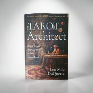 May include: A book titled "The Tarot Architect" with a dark background featuring celestial elements. The cover includes the author's name, Lon Milo DuQuette, and the subtitle "How to Become the Master Builder of Your Spiritual Temple."