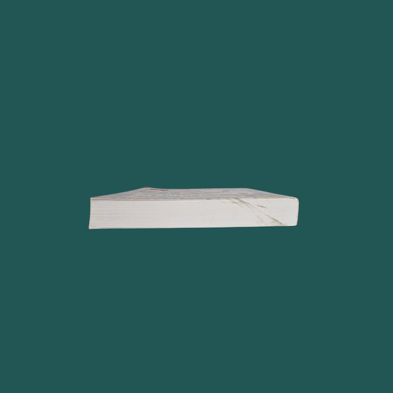 K&ouml;nnte beinhalten: Ein Stapel wei&szlig;es Papier mit einem marmor&auml;hnlichen Design am oberen Rand. Das Papier ist rechteckig und scheint gebunden zu sein. Der Hintergrund ist eine einfarbige teal Farbe.