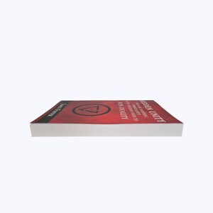 May include: A hardcover book titled "Hidden Unity" with a red cover and white pages. The cover features the title in white, a geometric symbol, and the author's name. The book is seen from a side angle.