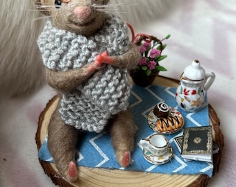 Needle felt mouse character wearing hand knitted scarf and glasses, with picnic accessories and polymer clay flowers