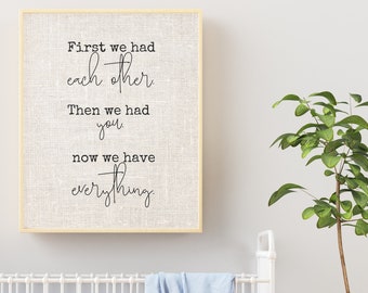 May include: A framed canvas print with a white background and black text that reads "First we had each other. Then we had you. Now we have everything."