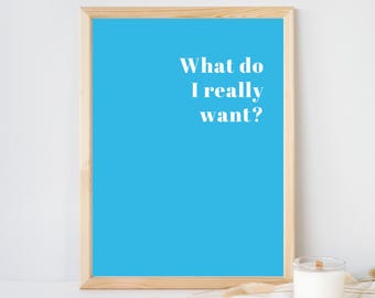 May include: A rectangular wall art print in a light wooden frame featuring a bright cyan blue background with the white text What do I really want? centered in the upper right quadrant of the print, presented in a clean, bold, serif typeface.