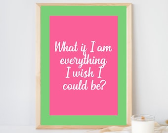May include: A framed wall art print featuring a bright pink rectangular center with a lime green border. The text "What if I am everything I wish I could be?" is printed in white in a cursive script font. The frame is made of light-colored wood.