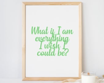 May include: A light wood frame containing a white print with the green text "What if I am everything I wish I could be?" and the text "| printable digital download |" positioned above the frame, accompanied by a white candle.