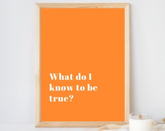 May include: A rectangular wooden frame containing a bright orange print with the white text "What do I know to be true?" centered in the lower left portion of the frame. The frame has a light natural wood grain finish and a simple profile.