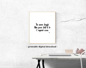 May include: A rectangular wall art print featuring black text on a white background that reads: The unseen struggle Often proves itself to be A required cocoon. The print is framed in a thin light wood frame and includes the text printable digital download.
