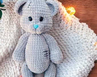 Personalized teddy bear of soft gray color for a baby that will be an individual gift for a girl or a boy