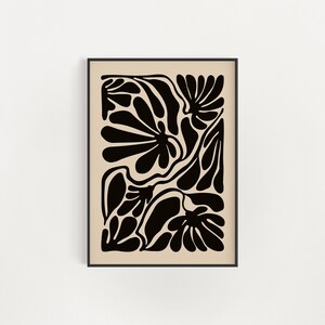 May include: Black and white abstract art print featuring a stylized floral design with organic shapes and lines. The print is framed in a black frame.