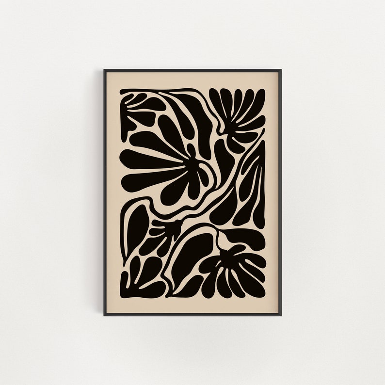 May include: Black and white abstract art print featuring a stylized floral design with organic shapes and lines. The print is framed in a black frame.