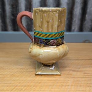 May include: A white ceramic mug with a black handle and the text "But First, Coffee" in a handwritten style. The mug is likely 11-15 ounces, perfect for a morning beverage.