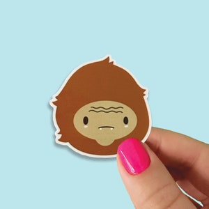 Bigfoot Head Glossy Sticker | Cute Cryptid Paranormal Sticker | Bigfoot Face 2x2 Decal Sticker | Waterproof Weatherproof Die Cut Vinyl