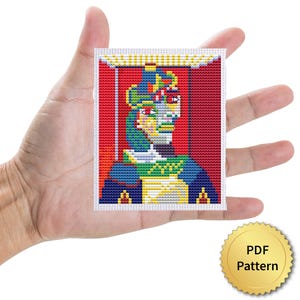 May include: A colorful cross-stitch pattern featuring a stylized portrait with a red background. The design incorporates shades of blue, green, yellow, and red, creating a vibrant and detailed image. A gold-colored PDF pattern seal is in the lower right corner.
