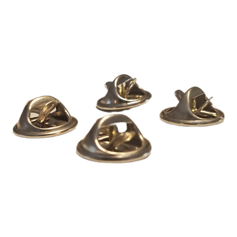 May include: Four gold-toned metal pin backs with a spring-loaded mechanism. The pin backs are designed to be used with a variety of pins and badges.