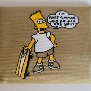 May include: Tan wallet featuring a cartoon image of Bart Simpson with a skateboard. Bart is yellow with a white shirt and brown shorts. The speech bubble says, "I'm Bart Simpson, who the hell are you?"